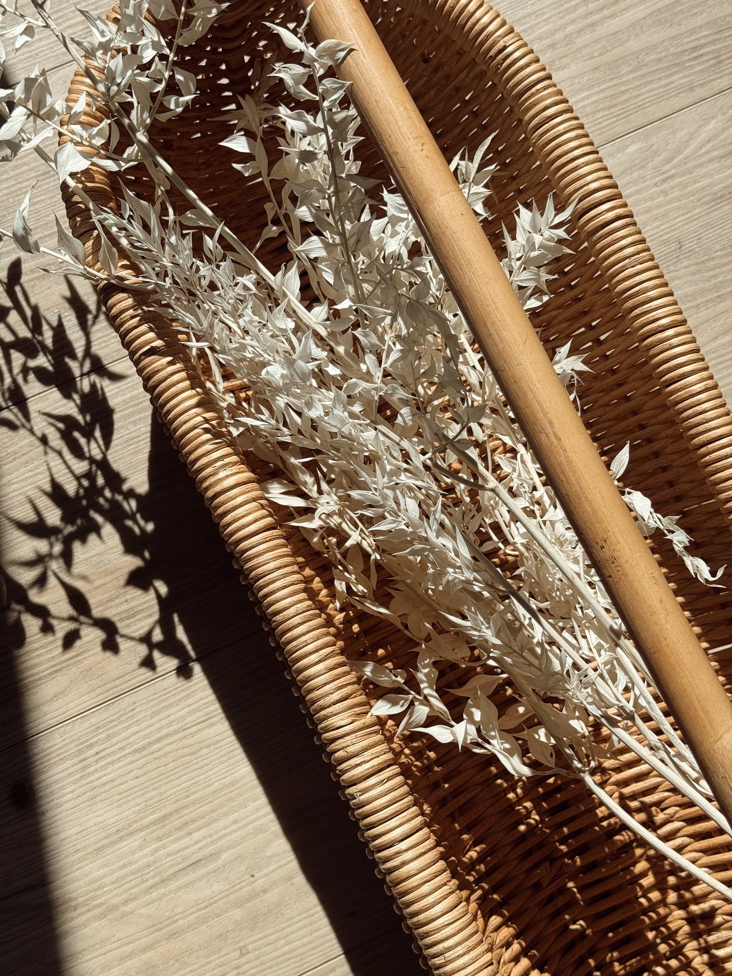 handwoven rattan basket with curved handle