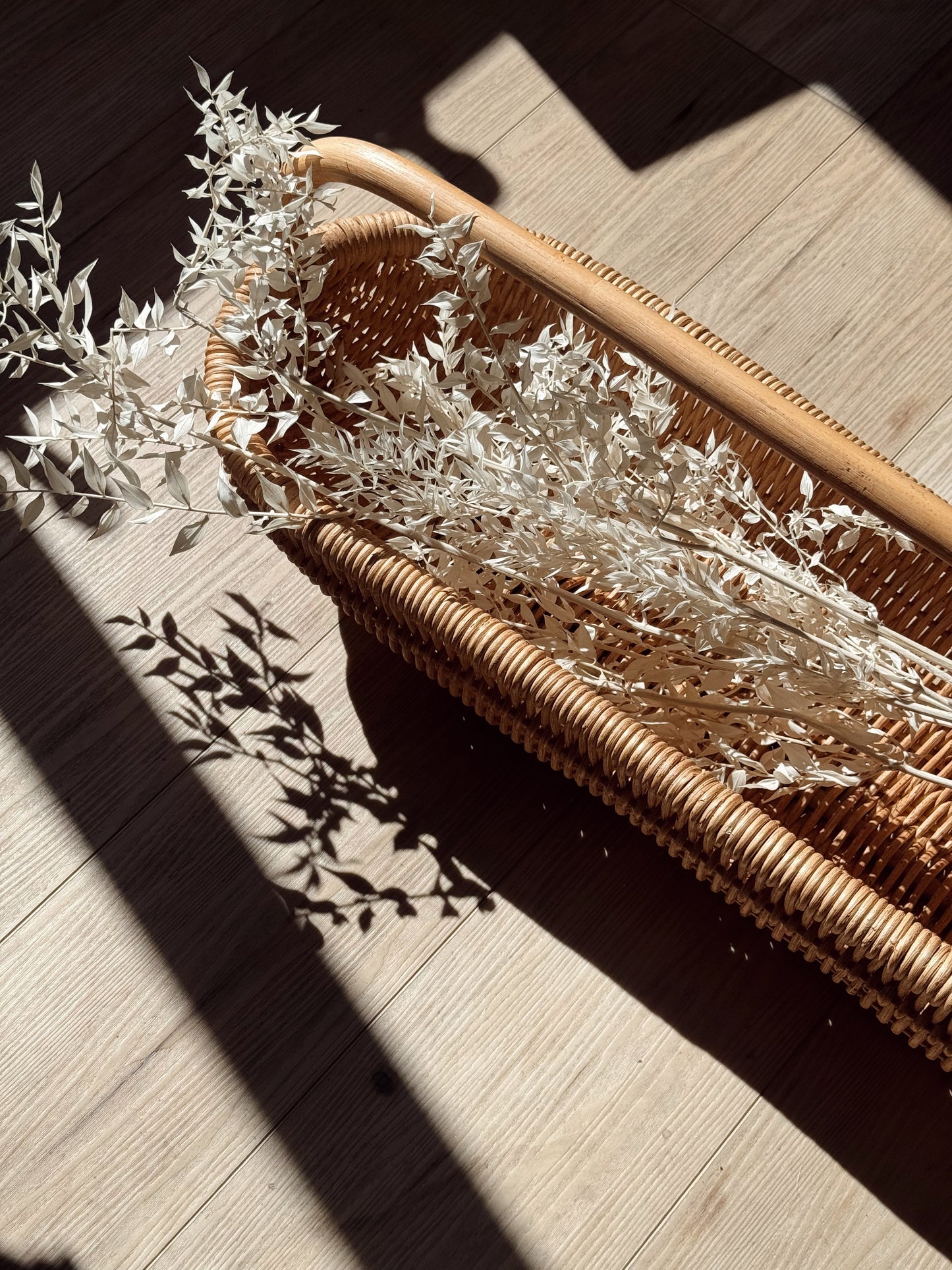 handwoven rattan basket with curved handle