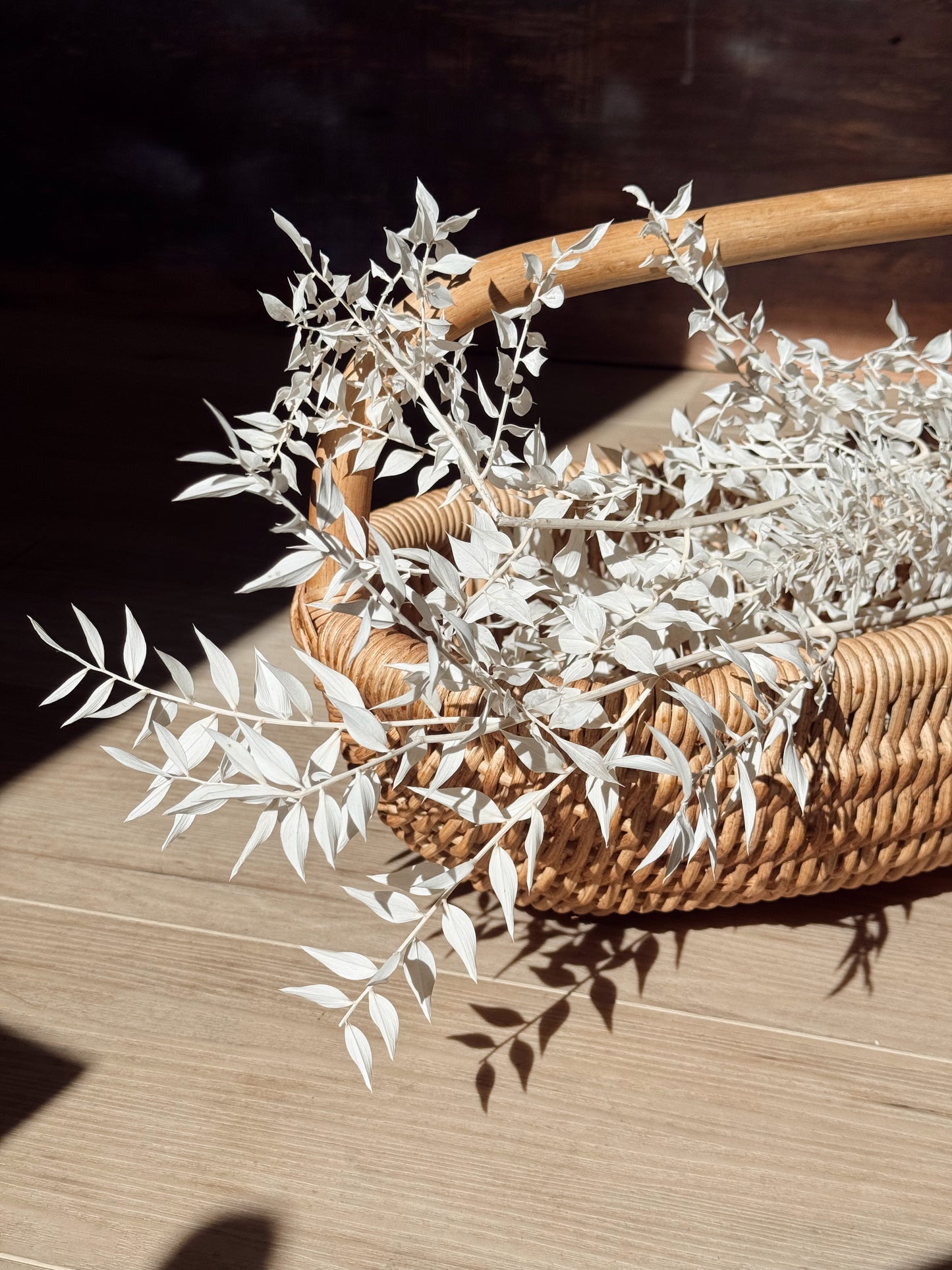 handwoven rattan basket with curved handle