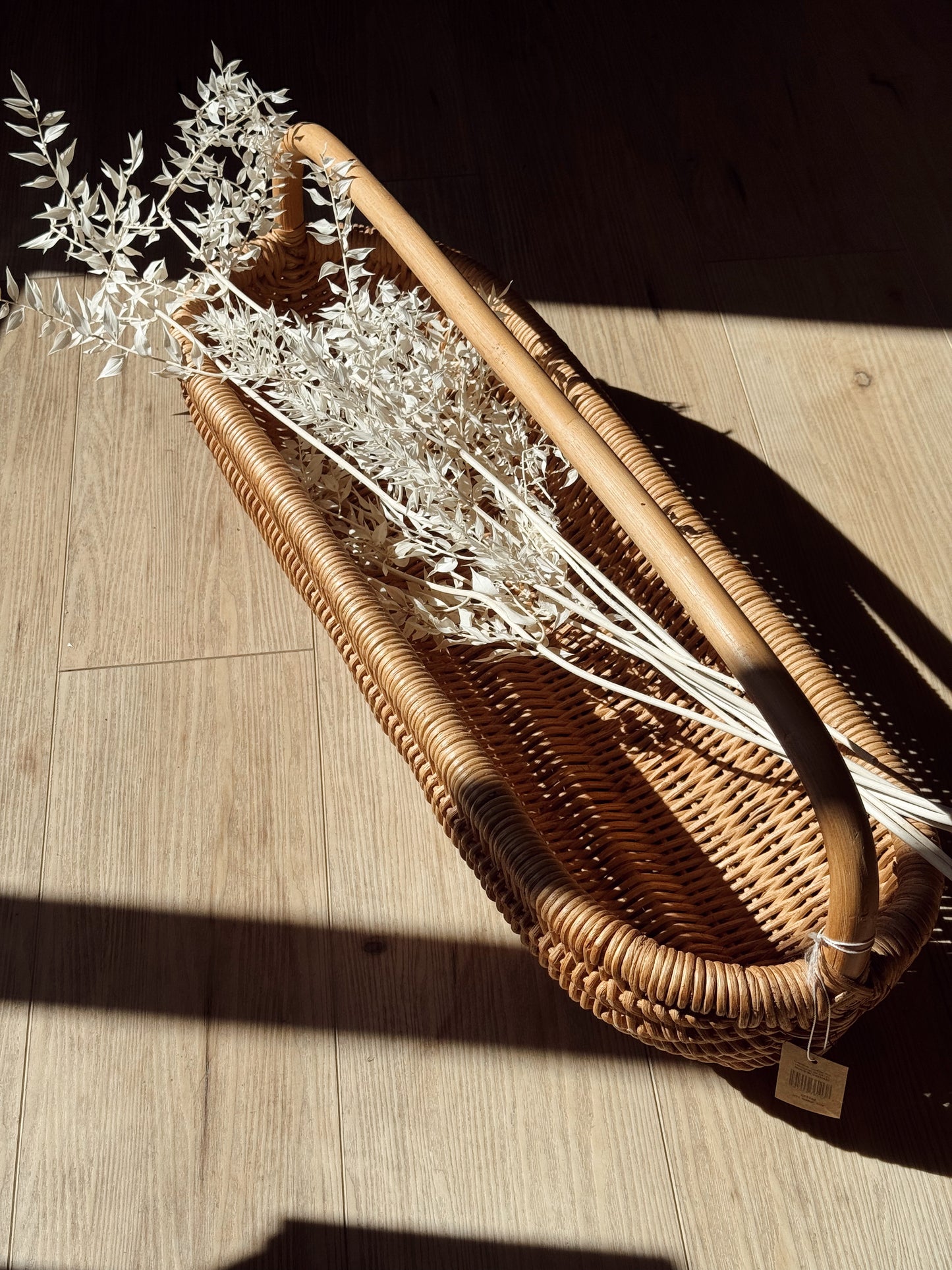 handwoven rattan basket with curved handle